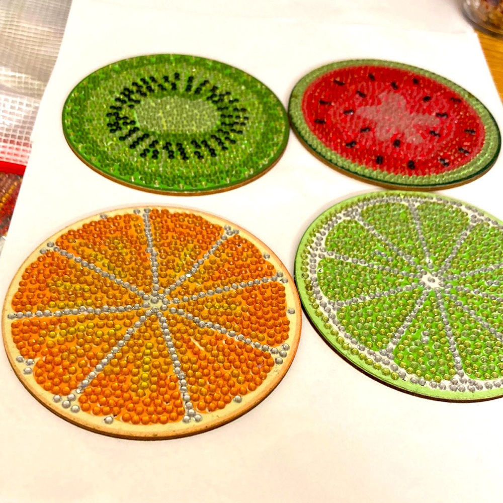4 cut up fruit coasters on wood background.  Handmade.  Dot crystal bme4019